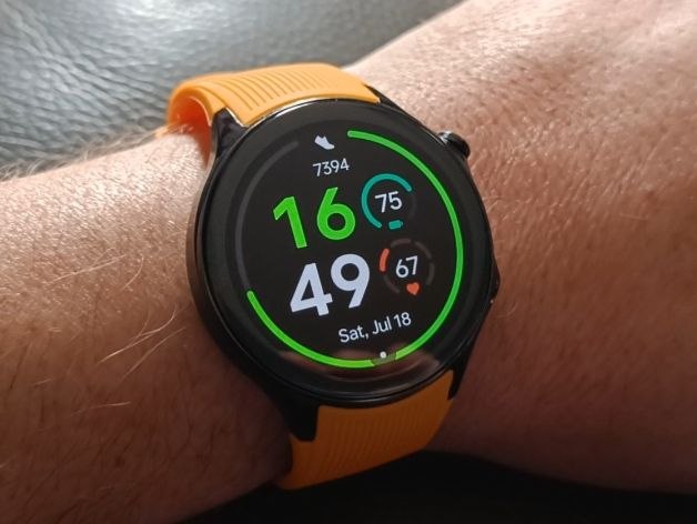 Samsung Galaxy Watch with orange strap on wrist